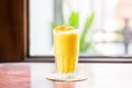 a frostcovered glass of mango lassi indicating a refreshing cold drink