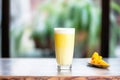 a frostcovered glass of mango lassi indicating a refreshing cold drink