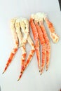 frosted Alaska king crab legs closeup photo on white table background Royalty Free Stock Photo