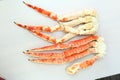 frosted Alaska king crab legs closeup photo on white table background Royalty Free Stock Photo