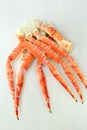 frosted Alaska king crab legs closeup photo on white table background Royalty Free Stock Photo