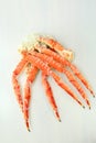 frosted Alaska king crab legs closeup photo on white table background Royalty Free Stock Photo
