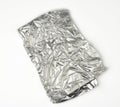 Frosted crumpled piece of foil on white background