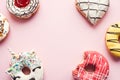 Frosted donuts on pink background