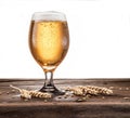 Frosted glass of beer on the wooden table. Royalty Free Stock Photo