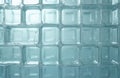 Frosted glass block wall with square cells and subtle water droplets. Translucent material forms a grid pattern, suitable for Royalty Free Stock Photo