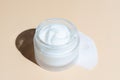 Frosted glass jar of moisturizer cream on beigebackground. Natural eco-friendly beauty product branding, packaging design. Cream Royalty Free Stock Photo