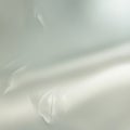 Frosted glass with a translucent appearance, diffusing light for privacy. The surface texture is smooth Royalty Free Stock Photo