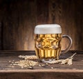 Frosted mug of beer on the wooden table. Royalty Free Stock Photo