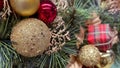 Frosted pine cones, red gingham bow, and berries creating a rustic Christmas background Royalty Free Stock Photo