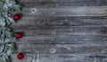 Frosted snow covered evergreen branches plus red ball ornaments on weathered wooden planks for a merry Christmas or happy New Year Royalty Free Stock Photo