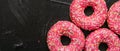 Frosted sprinkled donuts, sweet pastry dessert on rustic wooden background, doughnuts as tasty snack, top view food brand flat lay