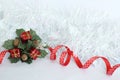 frosted white wreath with red ribbon and green leaves, red gifts on white background for party decoration Royalty Free Stock Photo