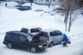 Frosts in Siberian town Novosibirsk. Technical service is trying to warm up and start the frozen car