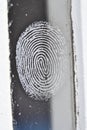 Frosty fingerprint on glass surface highlighting unique winter patterns Royalty Free Stock Photo