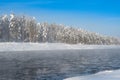 Frosty fog over winter river with snow and forest on bank Royalty Free Stock Photo