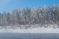 Frosty fog over winter river with snow and forest on bank Royalty Free Stock Photo