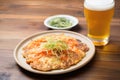 frosty glass of beer beside hot kimchi pancake