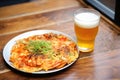 frosty glass of beer beside hot kimchi pancake