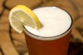 Frosty glass of beer with lemon slice Royalty Free Stock Photo