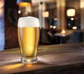 Frosty glass of light beer on the bar counter.