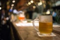 Frosty glass of light beer on the bar counter. Beer tap in Brussel Belgium