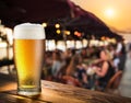 Frosty glass of light beer on the bar counter in the open-air cafe Royalty Free Stock Photo