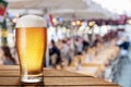 Frosty glass of light beer on the bar counter in the open-air cafe Royalty Free Stock Photo