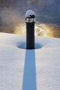 Frosty lamp post on snowy pier