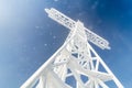 Frosty metal cross from in winter time contrasting the blue sky Royalty Free Stock Photo