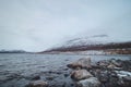 Frosty morning at Lake Ylinen Kilpisjarvi overlooking Saana mountain, which is immersed in a white mist in the northwestern Royalty Free Stock Photo