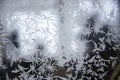 Frosty pattern on glass. Snowy frosty texture on a glass surface. Frost on the glass of the window. Frosty window. Snowflakes on Royalty Free Stock Photo