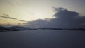 Frosty pond with snow in dark white winter day near small town. Stock footage. Aerial view of evening sunset landscape Royalty Free Stock Photo
