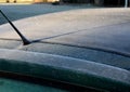 Frosty roof of a green passenger car with heavy icing. police may fine for poorly cleaned car. there must be no snow or ice in the Royalty Free Stock Photo