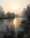 Frosty trees and backwater reflection in sunset time