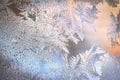 Frosty Window Glass with Natural Ice Patterns and Blurred Colorful Background. Winter Holidays Season, Fantasy World Concept Royalty Free Stock Photo