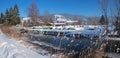 Frosty winter landscape Schlierach river, colorful rowing boats at the riverside, view to bavarian alps