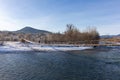 A frosty winter morning on a mountain river, the rays of the rising sun illuminate the panorama of the mountainous area. Royalty Free Stock Photo