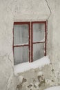 Frosty winter window, with old curtains