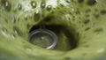 Frothing foam of green matcha tea in slow motion close-up.