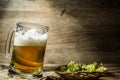 Frothy beer in mug standing on table Royalty Free Stock Photo
