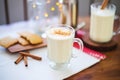 frothy eggnog closeup with nutmeg grater