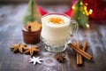 frothy eggnog in a decorated glass, sugar rim, star anise atop