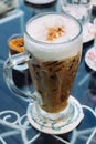 Frothy, layered cappuccino in a clear glass