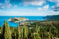 Frourio peninsular and Assos village with beautiful cypress trees in foreground. Kefalonia island, Greece