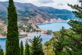 Frourio peninsular and Assos village with beautiful sea bay and cypress trees in foreground. Kefalonia island, Greece