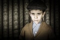 Frowning child in vintage clothes and hat Royalty Free Stock Photo