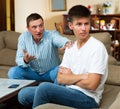 Frowning teen boy with berating father