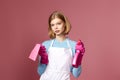 frowning woman cleaner apron with cleaning rag and detergent sprayer