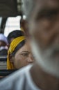 Frowning woman with yellow scarf on the bus from Amritsar to Wagah border